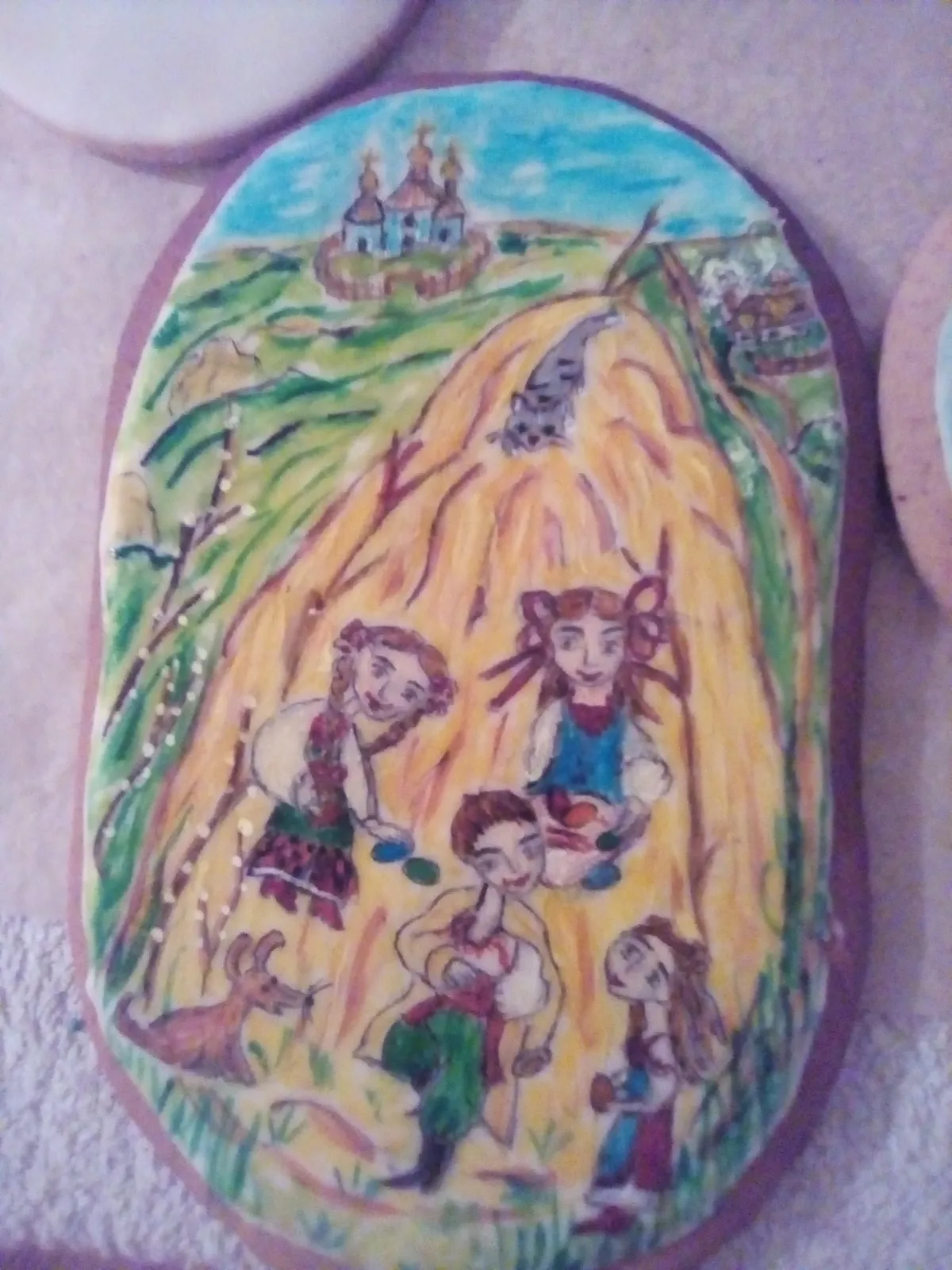 Hand-painted cookie with kids by a haystack