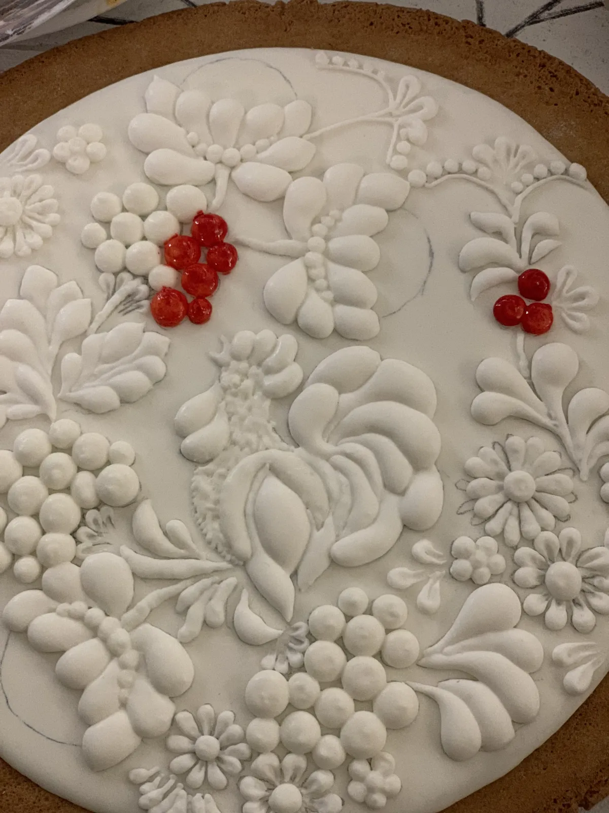 Cookie with white relief floral pattern