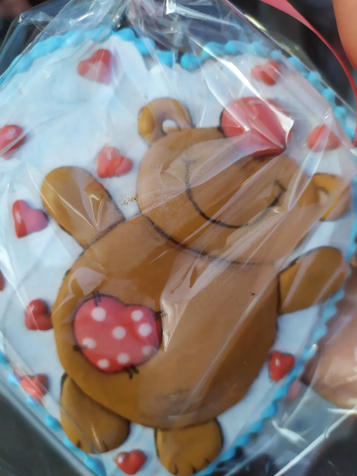 Hand-painted teddy bear hugging heart cookie